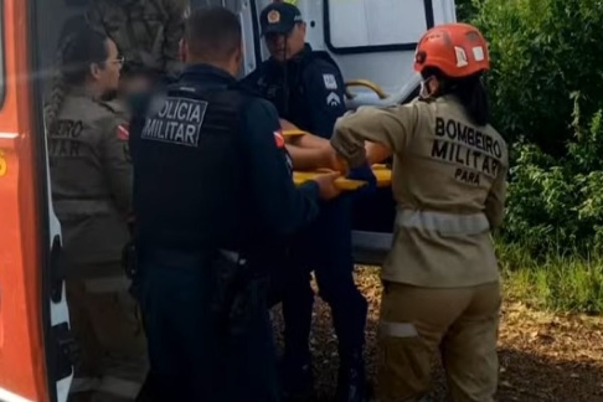 Equipe de resgate colocando pessoa em maca na ambulância dos Bombeiros.